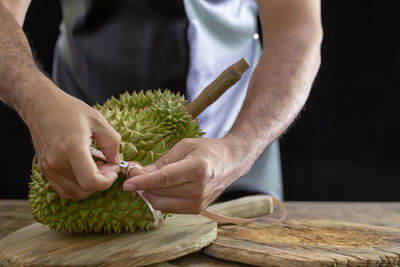 Midsection of man preparing food on cutting board