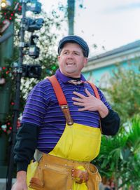 Portrait of man wearing overalls standing outdoors