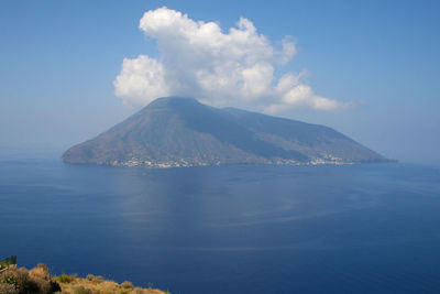 Scenic view of sea and mountains against sky