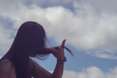 Portrait of woman against sky