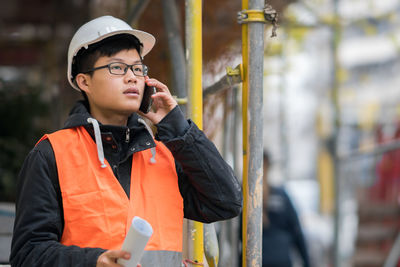 Engineer in reflective clothing talking on mobile phone