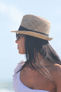 Close-up of mature woman wearing hat while standing against sky during sunny day