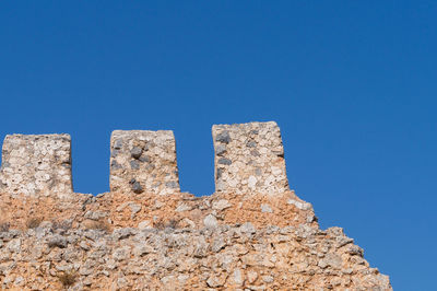 Low angle view of built structure against clear blue sky