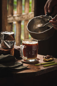 Cropped hand of woman making food on table