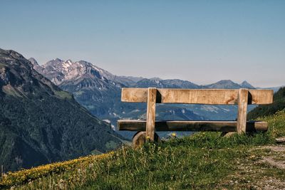 Scenic view of field and mountain against clear sky