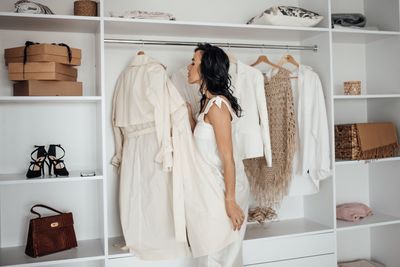 Happy woman getting dressed at home