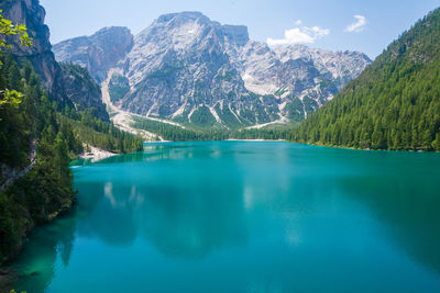 Scenic view of lake and mountains against blue sky