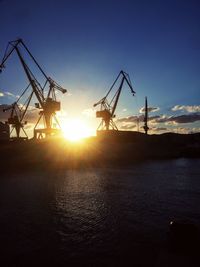 Boats in sea at sunset