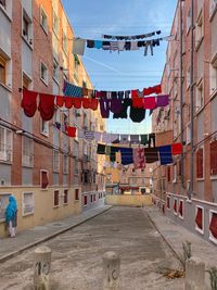 Clothes drying on street amidst buildings in city