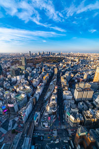 High angle view of city street and buildings against sky