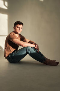 Handsome young man in t-shirt and jeans alone