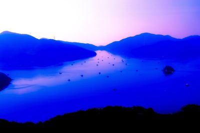 Scenic view of silhouette mountains against sky at sunset