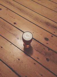 High angle view of wine glass on wooden table