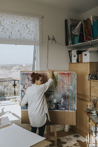 Artist preparing painting in studio