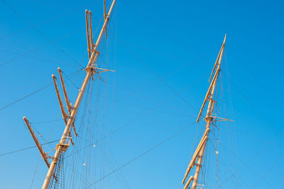 Low angle view of sailboat against clear blue sky