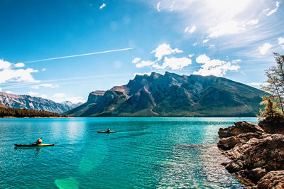 Scenic view of sea and mountains against sky