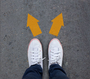 Low section of man standing on road