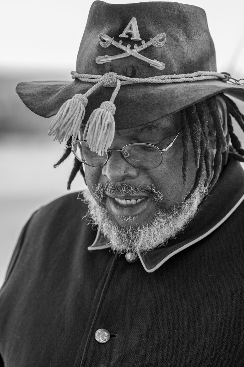 PORTRAIT OF SMILING MAN WEARING HAT