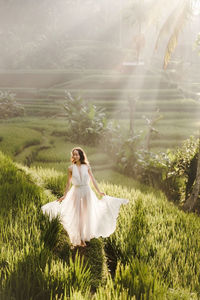 Woman with white flowers on field