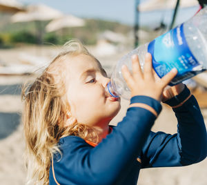 Portrait of woman drinking water from bottle