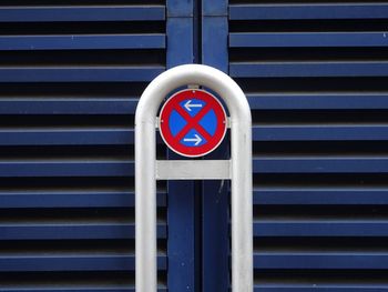 Close-up of no parking sign against shutter