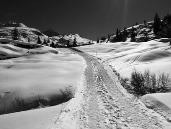 Scenic view of snow covered mountains against sky