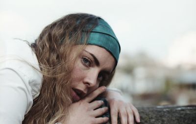 Close-up portrait of woman against sky