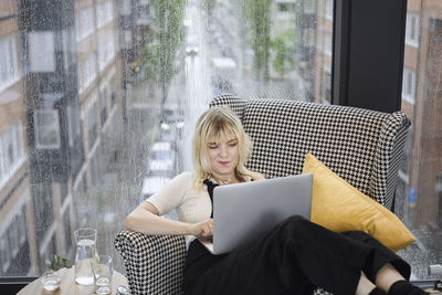 Businesswoman in office using laptop