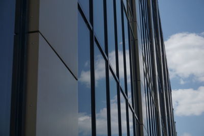 Low angle view of glass building against sky