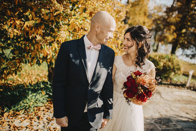 Couple holding umbrella during autumn