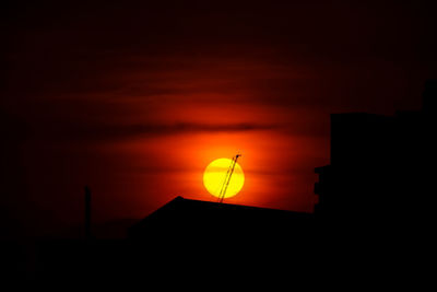 Low angle view of silhouette buildings against sky during sunset