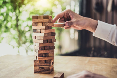 Person playing jenga on table