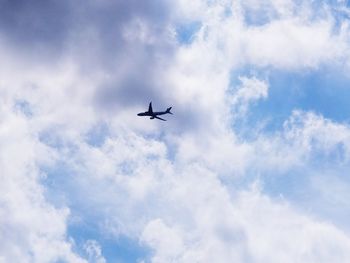 Low angle view of airplane flying in sky