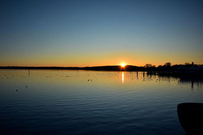 Scenic view of lake against sky during sunset