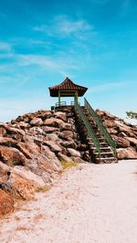Gazebo on rock against sky