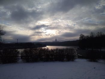 Scenic view of frozen lake against sky during sunset