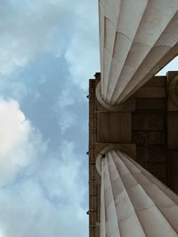 Low angle view of building against cloudy sky