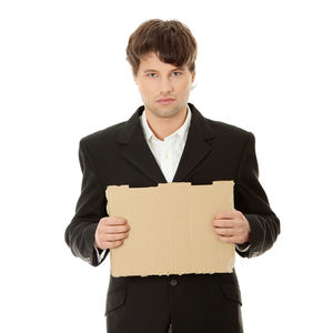 Portrait of young man standing against white background