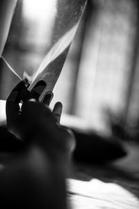 Close-up of hand holding glass window