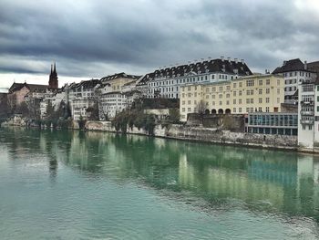 Buildings in city against cloudy sky