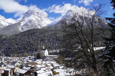 Aerial view of townscape by snow covered mountains