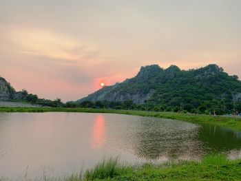 Scenic view of lake against sky during sunset