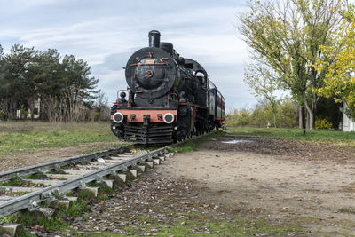 Train on railroad track against sky