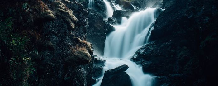 Panoramic view of waterfall in forest