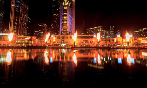 Reflection of illuminated buildings in river at night