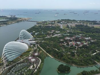 High angle view of buildings by sea against sky