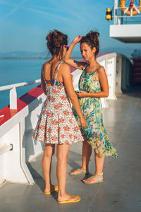 Friends talking while standing in cruise