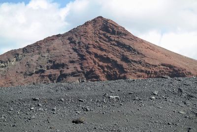 Scenic view of volcanic mountain against sky