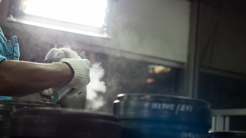 Midsection of man working in factory