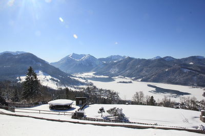 Scenic view of snowcapped mountains against clear blue sky